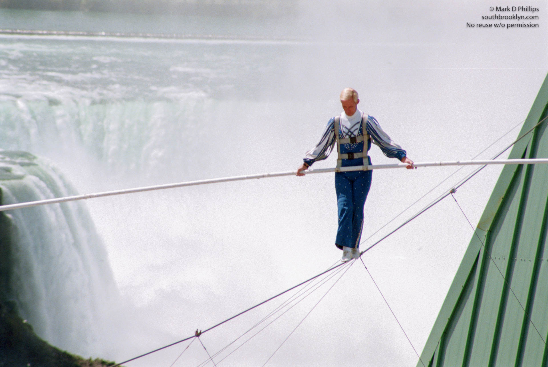 Jay Cochrane skywalks in Niagara Falls on May 21, 2002, with the American Falls of Niagara at his back. ©Mark D Phillips